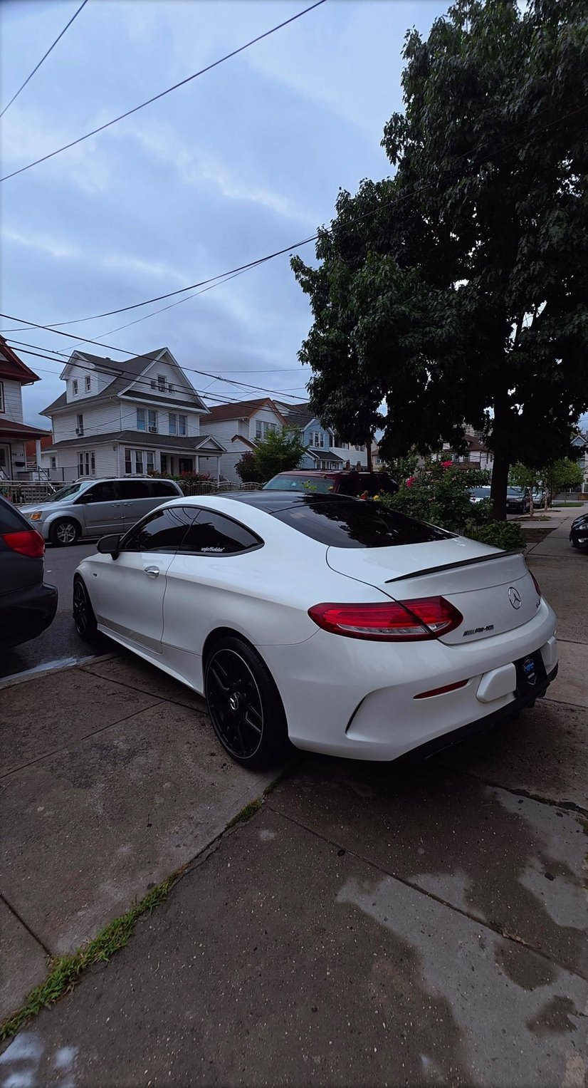 Rear view of a detailed white Mercedes-Benz C-Class coupe