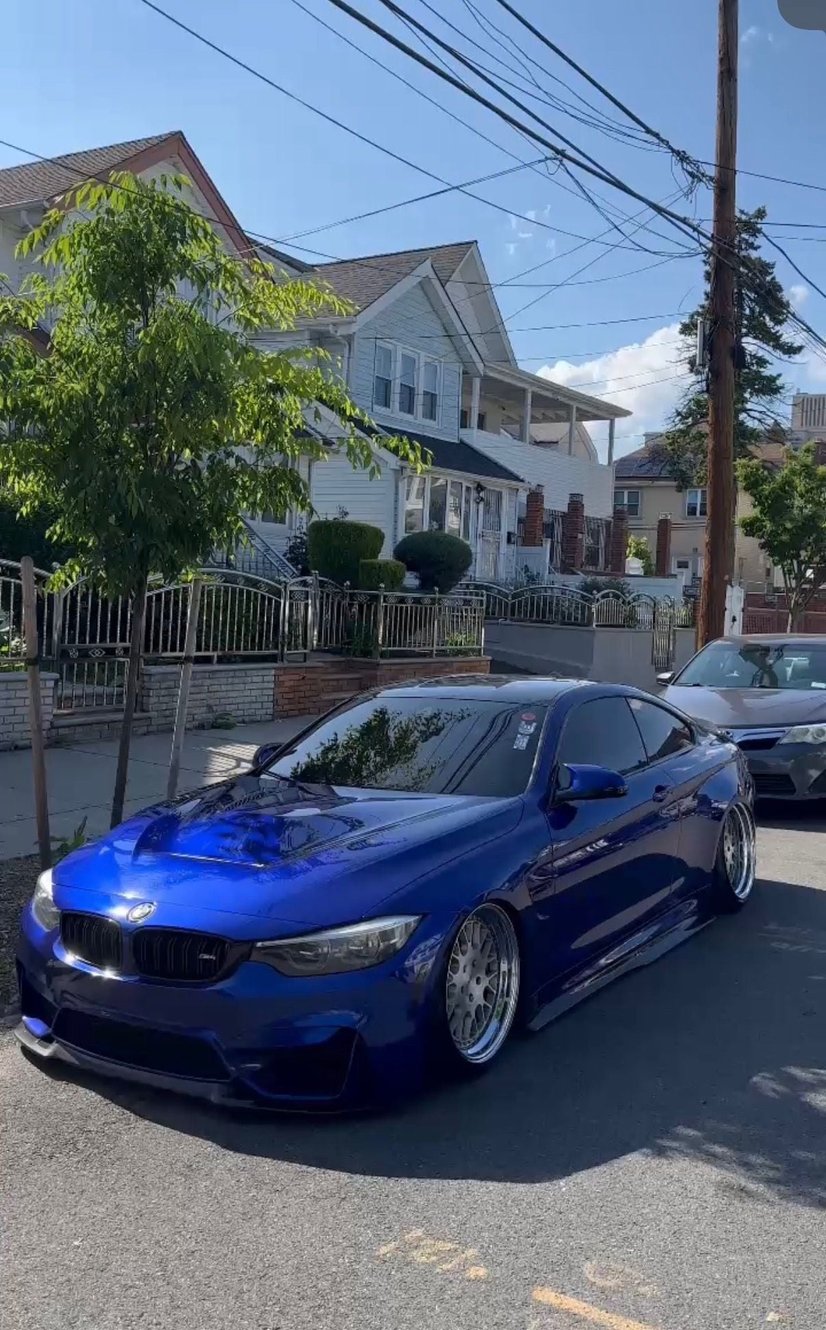 Blue BMW M4 with a glossy detailed finish